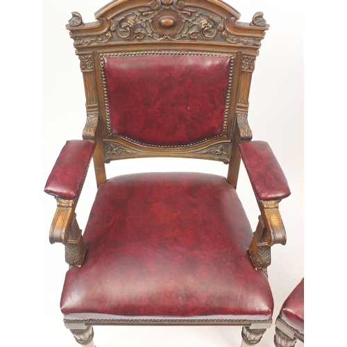 2067 - Pair of carved walnut elbow chairs with red upholstered back, seat and elbow pads, each 107cm high