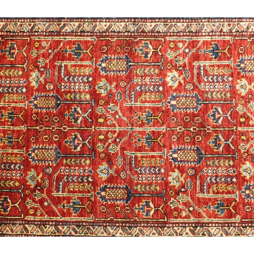 2032A - Red and blue ground rug with all over geometric design, 140cm  x 102cm