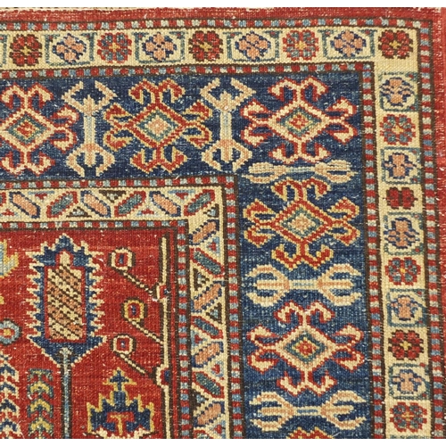 2032A - Red and blue ground rug with all over geometric design, 140cm  x 102cm