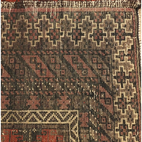 2062 - Persian red ground rug with all over geometric design, 240cm x 118cm