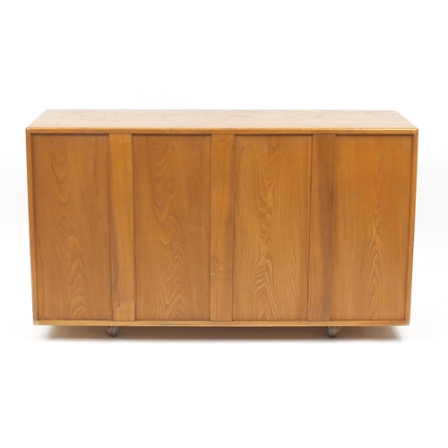 2017 - Ercol Windsor light elm sideboard with three cupboard doors above two drawers, 76cm H x 130cm W x 44... 