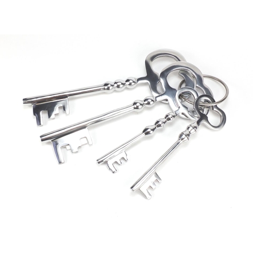 2227 - Novelty set of four oversized silvered keys, the largest 36cm in length