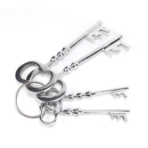 2227 - Novelty set of four oversized silvered keys, the largest 36cm in length