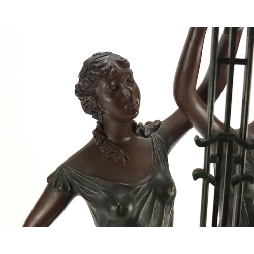 2157 - Art Nouveau style bronzed swinging clock with two scantily dressed females, 79.5cm high