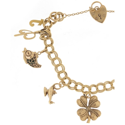 2358 - 9ct gold charm bracelet with gold charms including a four leaf clover, 22.4g