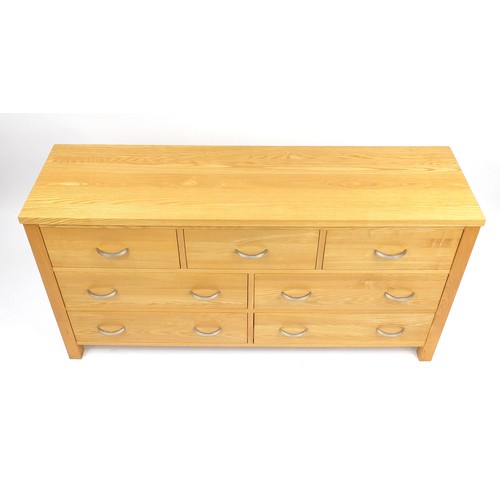 2055 - Contemporary light oak seven drawer chest, 76cm H x 146cm W x 42cm D