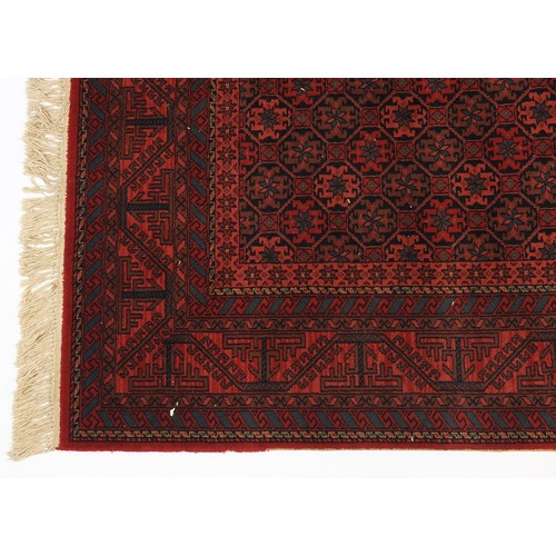 2035 - Red ground rug with all over geometric design, 205cm x 140cm