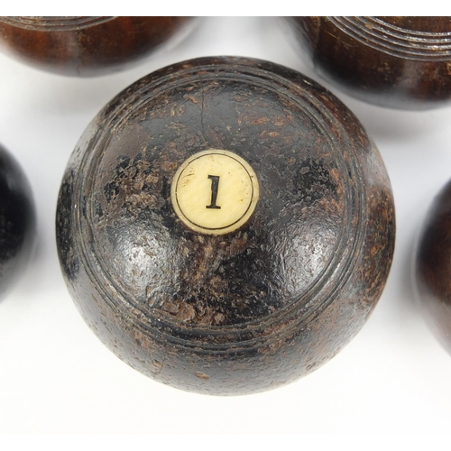 150 - Two sets of Victorian hardwood carpet bowls with ivory inlay, the largest approximately 5.5cm in dia... 