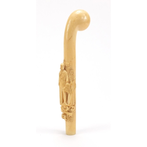 129 - Good 19th century ivory walking stick handle finely carved in relief with a soldier in military dres... 