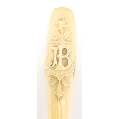 124 - Victorian carved ivory cigarette holder housed in a tooled leather velvet lined case, 11cm in length