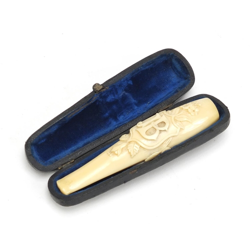 124 - Victorian carved ivory cigarette holder housed in a tooled leather velvet lined case, 11cm in length