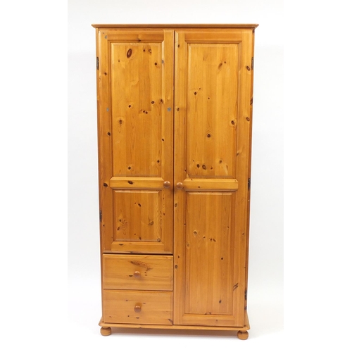 65 - Pine two door wardrobe fitted with two drawers to the base, 175cm H x 88cm W x 54cm D