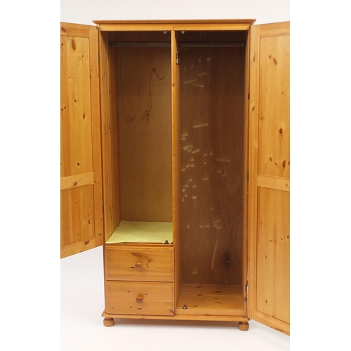 65 - Pine two door wardrobe fitted with two drawers to the base, 175cm H x 88cm W x 54cm D