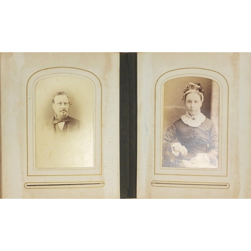 941 - Victorian black and white cabinet cards arranged in a tooled leather album