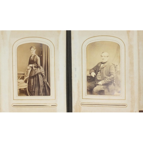 941 - Victorian black and white cabinet cards arranged in a tooled leather album