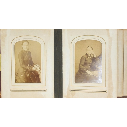 941 - Victorian black and white cabinet cards arranged in a tooled leather album