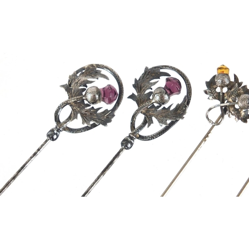 12 - Two pairs of unmarked silver thistle design hat pins set with amethyst and citrine, the largest 28.5... 