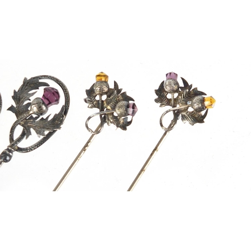 12 - Two pairs of unmarked silver thistle design hat pins set with amethyst and citrine, the largest 28.5... 