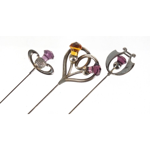 7 - Three Art Nouveau unmarked silver thistle design hat pins set with amethyst and citrine, the largest... 