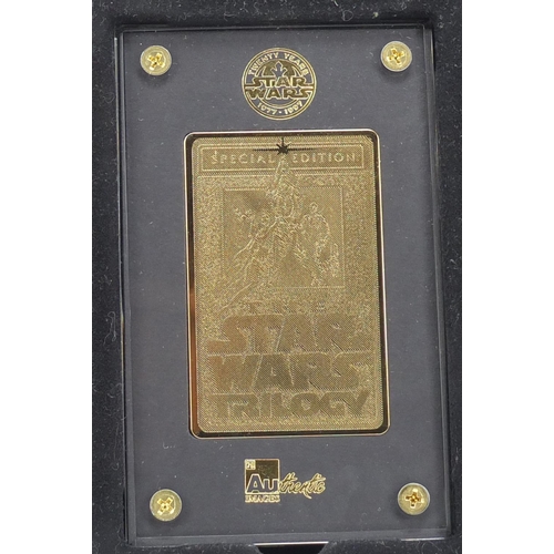 2464 - Star Wars 24ct gold collectors cards comprising A New Hope and Star Wars trilogy