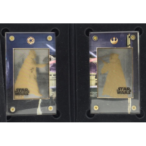 2464 - Star Wars 24ct gold collectors cards comprising A New Hope and Star Wars trilogy