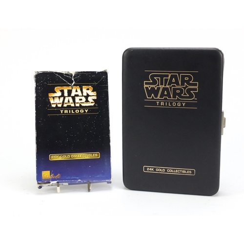 2464 - Star Wars 24ct gold collectors cards comprising A New Hope and Star Wars trilogy