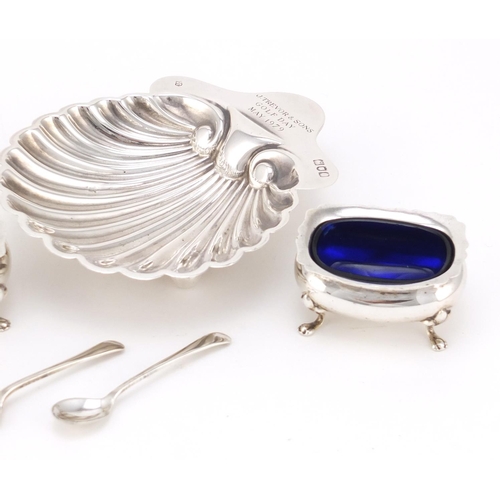 2461 - Silver shell shaped dish and a pair of silver open salts with blue glass liners, various hallmarks, ... 