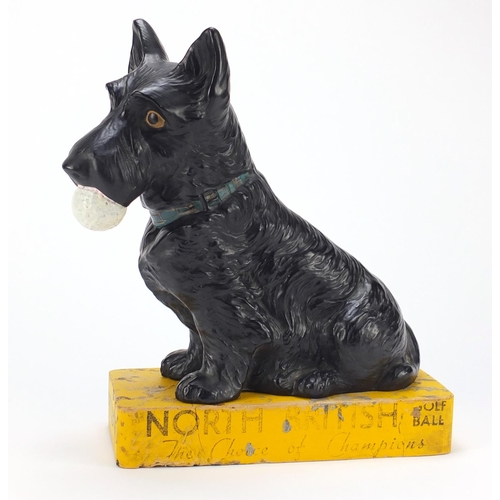 111 - Rare North British Golf ball advertising pottery figure of a Scottie dog holding a golf ball on stan... 