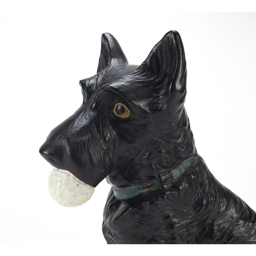 111 - Rare North British Golf ball advertising pottery figure of a Scottie dog holding a golf ball on stan... 