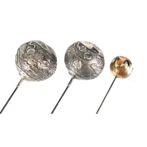 17 - Pair of Chinese silver hat pins and a Japanese Satsuma example, the pair by Po Cheng, the largest 26... 