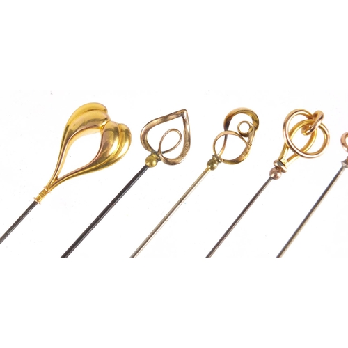 18 - Five Art Nouveau 9ct gold hat pins, the largest 20cm in length
