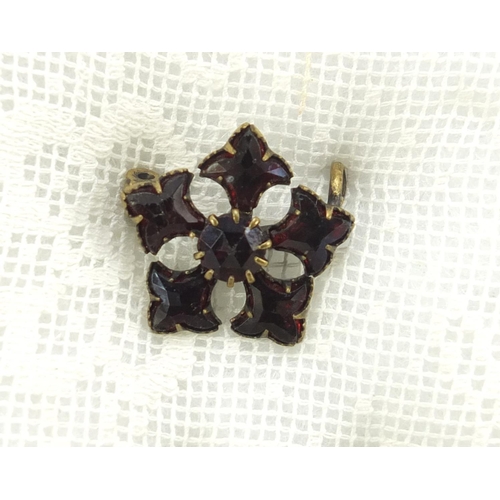 784 - Victorian and later garnet jewellery, comprising 
three brooches and two tie pins, housed in a mahog... 