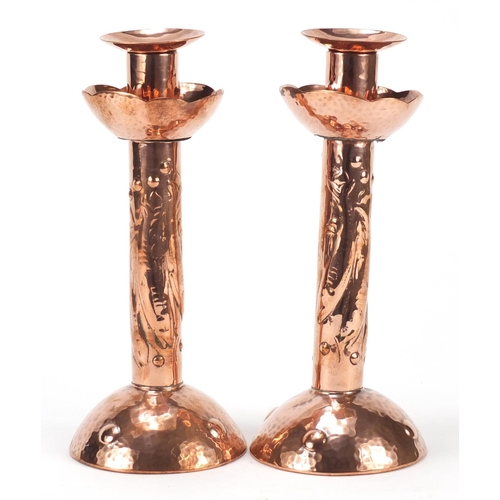 581 - Pair of Arts & Crafts copper candlesticks embossed with fish by Newlyn, each 21.5cm high