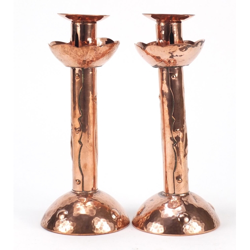 581 - Pair of Arts & Crafts copper candlesticks embossed with fish by Newlyn, each 21.5cm high