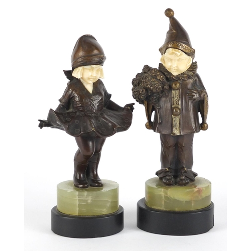 578 - Pair of Art Deco patinated bronze ivory and onyx figures of children raised on black slate bases, th... 