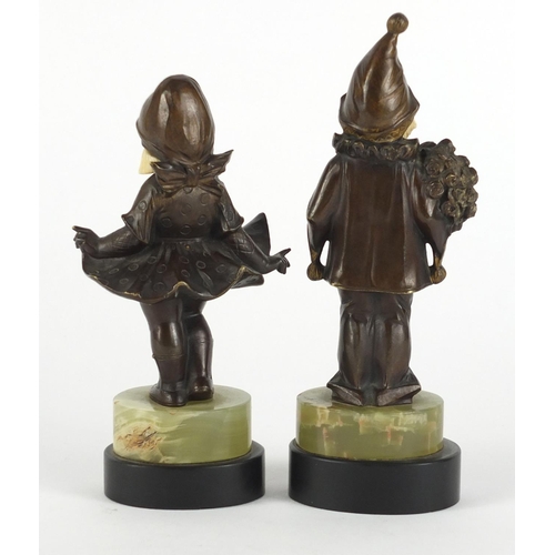 578 - Pair of Art Deco patinated bronze ivory and onyx figures of children raised on black slate bases, th... 