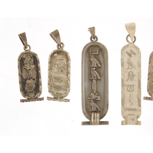 2587 - Six silver Egyptian hieroglyphic pendants, the largest 5cm in length, 23.6g