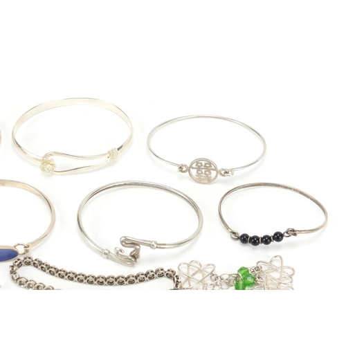 2602 - Eleven silver bracelets including some enamelled and some set with semi precious stones, 94.0g