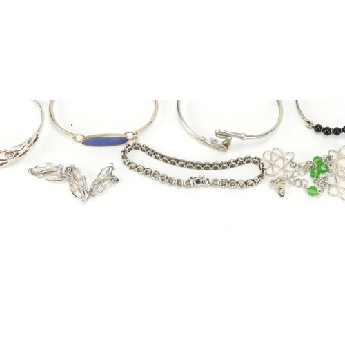 2602 - Eleven silver bracelets including some enamelled and some set with semi precious stones, 94.0g