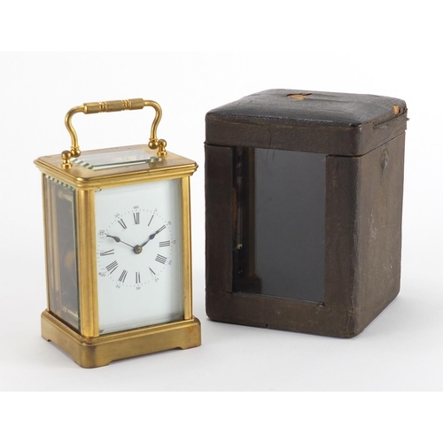 82A - Gilt brass carriage clock with enamelled dial, Roman numerals and velvet lined case, the back plate ... 