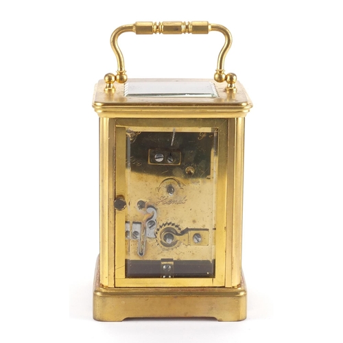 82A - Gilt brass carriage clock with enamelled dial, Roman numerals and velvet lined case, the back plate ... 