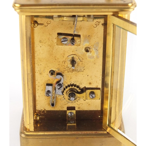 82A - Gilt brass carriage clock with enamelled dial, Roman numerals and velvet lined case, the back plate ... 