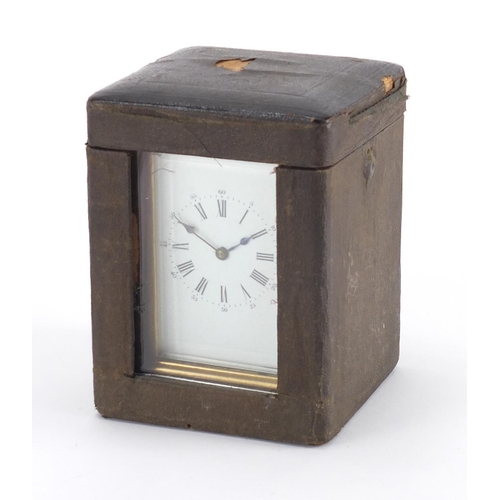 82A - Gilt brass carriage clock with enamelled dial, Roman numerals and velvet lined case, the back plate ... 