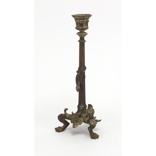 66 - 19th century patinated bronze candlestick with paw feet, the column decorated in relief with a lizar... 