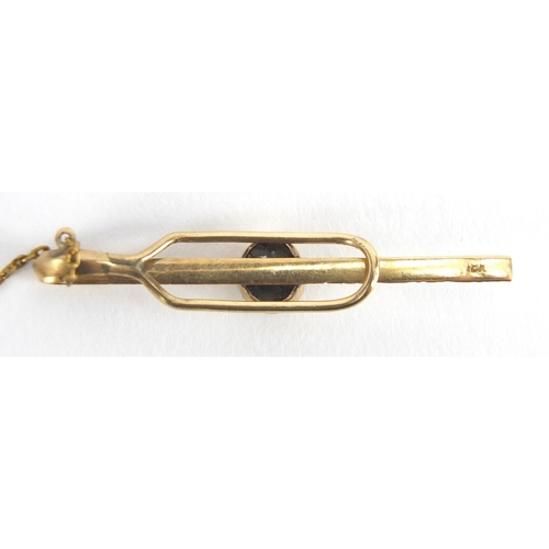 2623 - 10ct gold tie slide, set with a cabochon hardstone, 4.5cm in length, approximate weight 2.3g.