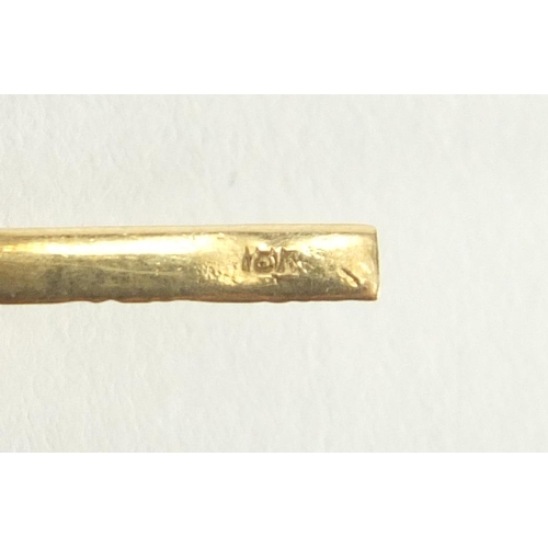 2623 - 10ct gold tie slide, set with a cabochon hardstone, 4.5cm in length, approximate weight 2.3g.