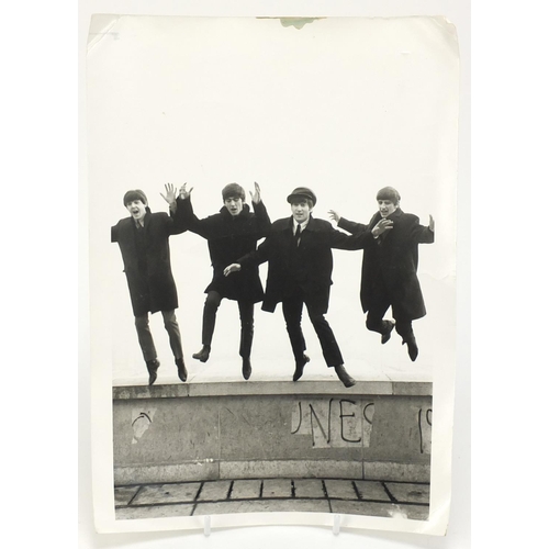 202 - Vintage black and white photograph of the Beatles jumping, 30.5cm x 23.5cm