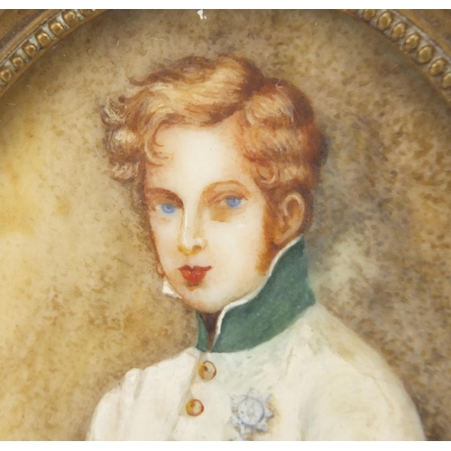 46 - Oval hand painted portrait miniature of a young gentleman in military dress, housed in a brass frame... 