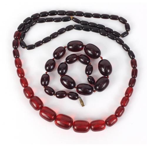 781 - Two cherry amber coloured bead necklaces, the largest 90cm in length, 147.0g