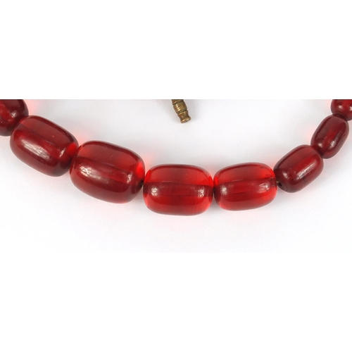 781 - Two cherry amber coloured bead necklaces, the largest 90cm in length, 147.0g